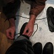 A fortunate servant helps to remove Mistress Troy's snow boots